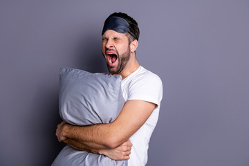 Poster - Portrait of his he nice-looking attractive exhausted sleepy bearded guy holding in hands pillow drowsiness going to bed isolated over gray pastel violet purple background