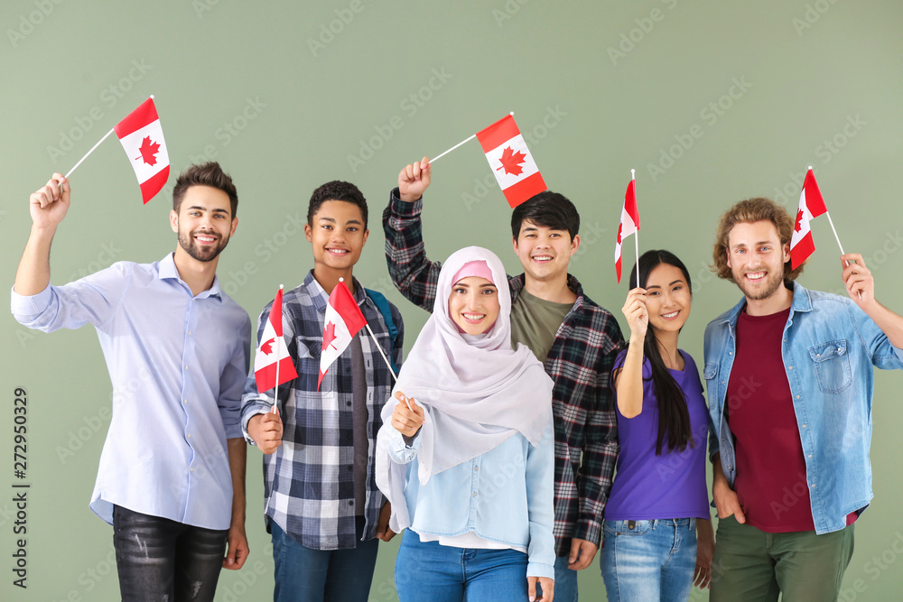 Group of students with Canadian flags on color background - obrazy, fototapety, plakaty 