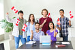 © Pixel-Shot - Group of students with Canadian flags in classroom