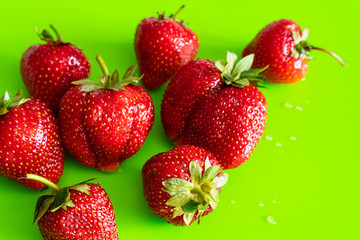 Red ripe berry of strawberry on green Matt background