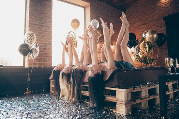 Sticker - Nice charming attractive lovely lovable feminine thin slender cheerful cheery ladies lying on bed raising hands legs up day dream in decorated lights loft industrial brick style interior room indoors