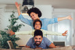 © Mediteraneo - Happy family posing on the couch together at home in the living room, selective focus.