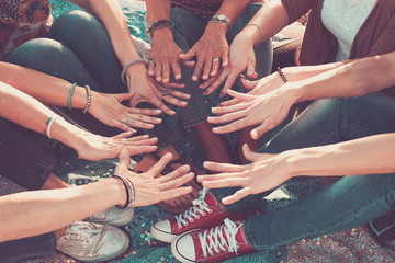 Wall Mural - team and friendship concept with crowd of hands and feet all together touching and cooperate - caucasian people friends enjoying the outdoor leisure activity - hippy love