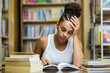 © Samuel B. - Black african american young girl student studying at the school university library