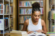 © Samuel B. - Black african american young girl student studying at the school university library