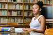 © Samuel B. - Black african american young girl student studying at the school university library