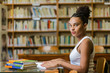 © Samuel B. - Black african american young girl student studying at the school university library
