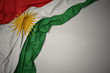 waving national flag of kurdistan on a gray background.