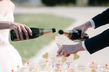 Man pours champagne into a glass from a bottle