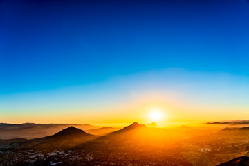 Wall Mural - Sunset over City, Mountain Peaks