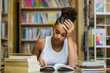 © Samuel B. - Black african american young girl student studying at the school university library