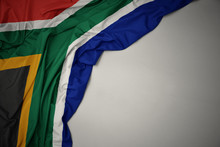 Waving National Flag Of South Africa On A Gray Background.