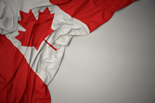 Waving National Flag Of Canada On A Gray Background.