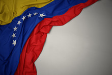 Waving National Flag Of Venezuela On A Gray Background.