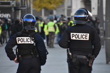 Helmeted Police Officers Photographed From Behind During A Protest