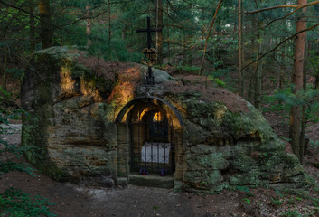 Wall Mural - Old rocky chapel with crucifix in spring sunny morning