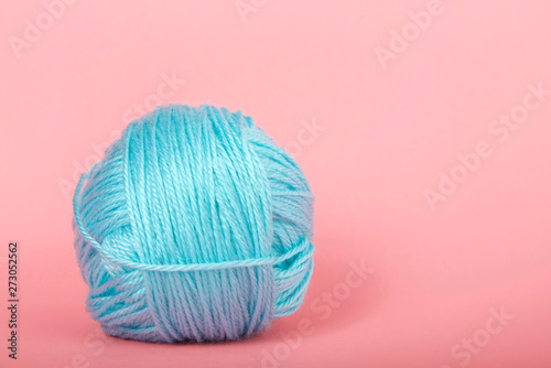 Single Ball Of Light Blue Baby Soft Thin Yarn On A Light Pink