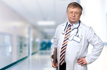 Young doctor man with stethoscope in clinic