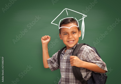 Young Hispanic Student Boy Wearing Backpack Front Of Blackboard with Graduati...