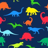 Fototapeta Dinusie - Seamless repeat pattern with colorful neon dinosaur silhouettes on a navy blue background