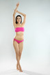 © New Africa - Full length portrait of attractive young woman with slim body in swimwear on white background. Space for text