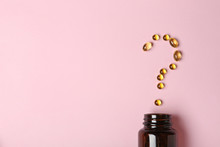 Question Mark Of Cod Liver Oil Capsules And Jar On Color Background, Flat Lay. Space For Text