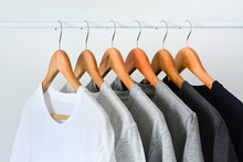 Close Up Collection Of Black, Gray And White Color (monochrome) Hanging On Wooden Clothes Hanger In Closet Or Clothing Rack Over White Background