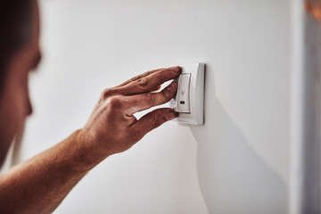 Wall Mural - Electrician repairing / fixing wires in the wall.