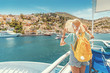 © EdNurg - Asian girl traveler with backpack and hat enjoys a sea cruise on a open ship deck. Tourism and vacation in Greece and mediterranean sra. Transport and travel inspiration