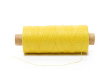 Yellow Spool Of Thread In A Horizontal Position On A White Background