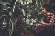 © Nejron Photo - African american woman mechanic repairing a motorcycle in a workshop