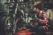 © Nejron Photo - African american woman mechanic repairing a motorcycle in a workshop