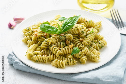 Cuadros en Lienzo fusili pasta with basil pesto and herbs, italian cuisine, gray stone background,
