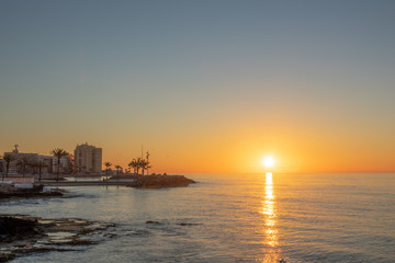 Wall Mural - Beach and rocks of Torrevieja center during sunrise