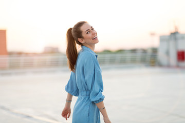 Wall Mural - portrait of a girl on a rooftop enjoying sunset