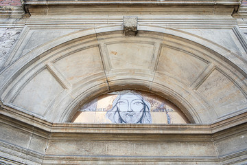 Wall Mural - Italian Church Facade Detail With Christ Face Bucharest Romania