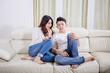 © Creativa Images - Happy young couple watching television at home