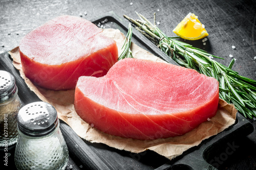Cuadros en Lienzo Raw tuna steak on a cutting Board with paper.