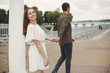 © hetmanstock2 - Cute couple in a city. Lady in a white dress. Boy in a green shirt