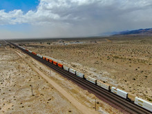 Cargo Locomotive Railroad Engine Crossing Arizona Desert Wilderness. Freight Train Passing By The Desert. USA