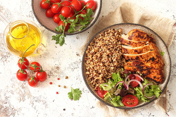 Healthy dinner.Grilled chicken and quinoa, mix salad and tomato 