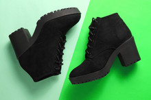 Black Suede Boots On A Two-ton Green Background. Top View