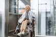 © Yakobchuk Olena - Mature lady in glasses on disabled carriage using elevator