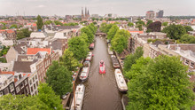 Aerial View Of A Barge Driving In The Canal Of Amsterdam, The Netherlands.