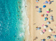 © AmazingAerialAgency - Aerial view of people relaxing under colorful parasols on beach