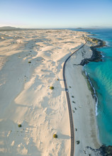 Aerial Panoramic View Of A Car Driving On The Road In Corralejo Dunes Natural Park In Fuerteventura, Canary Islands.