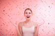© primipil - Portrait of laughing happy female model in pink background.