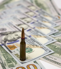 bullets on american dollars background Ammunition from the gun on money bills