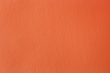 Abstract orange painted wall. Bright plaster colored texture