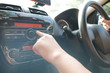 © airdone - Driver's Hand Press Button on Car Radio